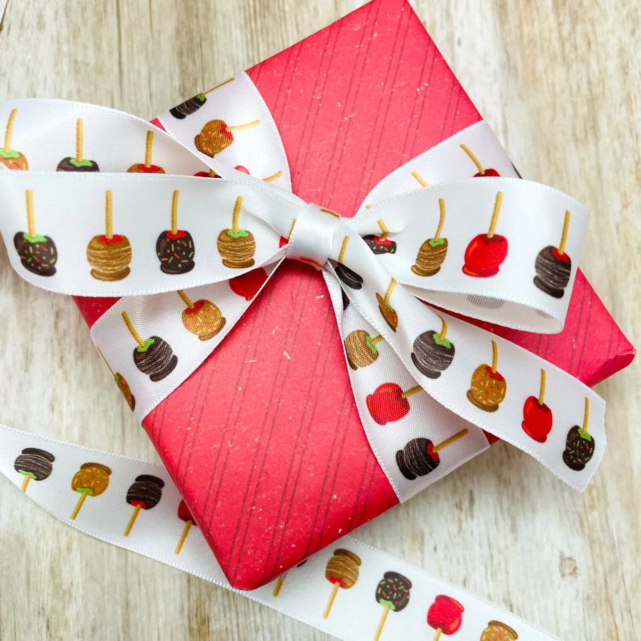 Candy apple ribbon with apples dipped in red, caramel and chocolate printed on 7/8" white satin