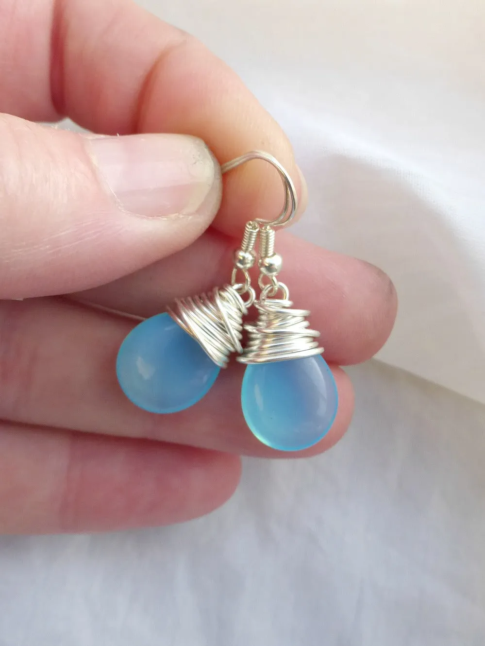 Sky blue transparent teardrop Czech Picasso glass, silver wire wrapping, sterling silver earrings.